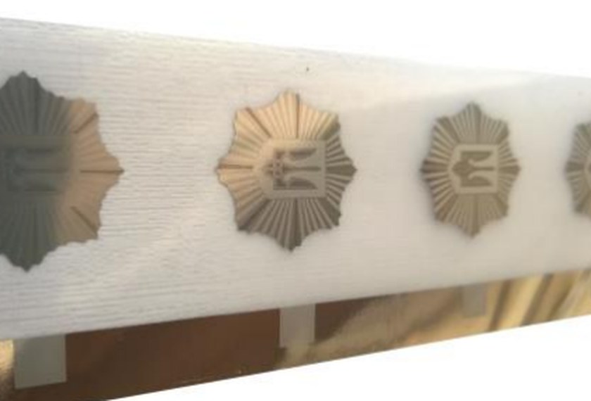 Hot stamping foil strip with repeated emblem